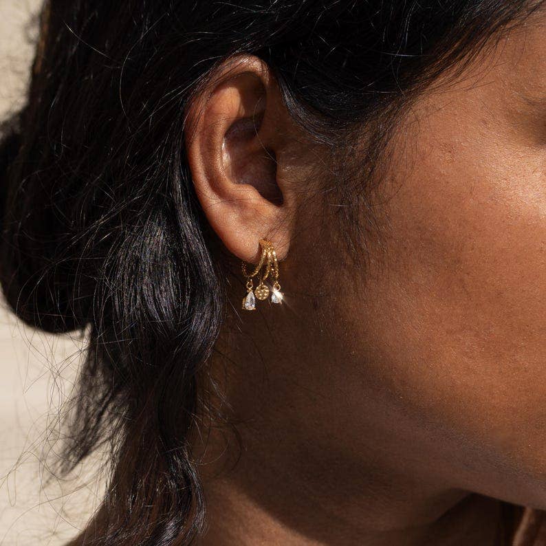 Boucles d'oreilles acier inoxydable trois anneaux ornée de zirconium