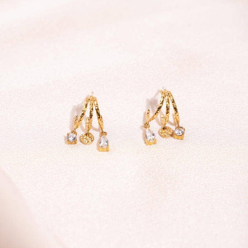Boucles d'oreilles acier inoxydable trois anneaux ornée de zirconium